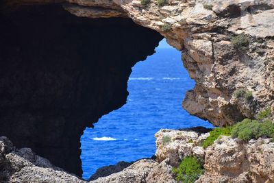 Scenic view of sea seen through cave