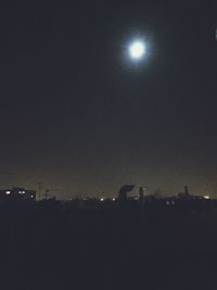 Low angle view of illuminated dark dark sky
