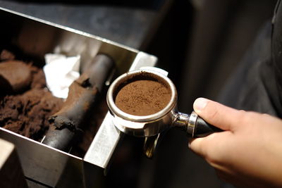 Close-up of hand holding coffee cup