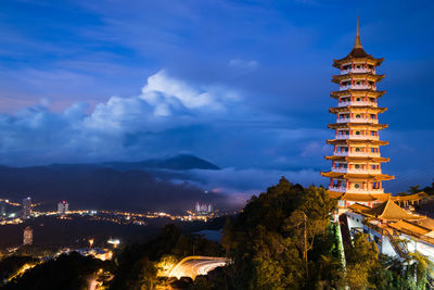 Illuminated pagoda against the sky during blue hour.