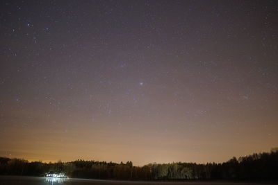 Scenic view of lake against sky at night