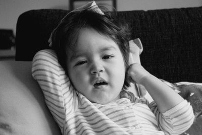 Portrait of cute baby relaxing on sofa at home