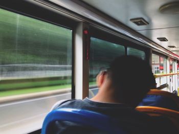 Rear view of man in train