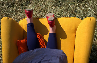 Directly above shot of woman on armchair outdoors