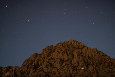 Low angle view of mountain against sky at night