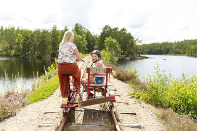 Mother with daughter riding handcar