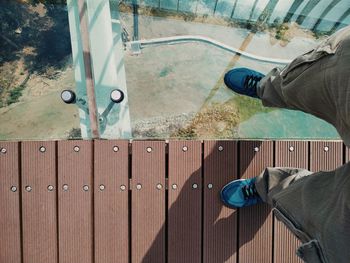 Low section of man standing on wooden door