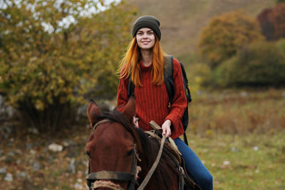 Young woman with a horse