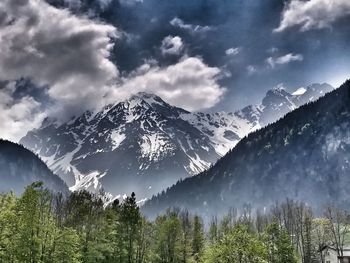 Scenic view of snowcapped mountains against sky