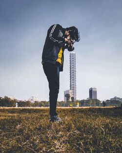 Man standing on field against sky