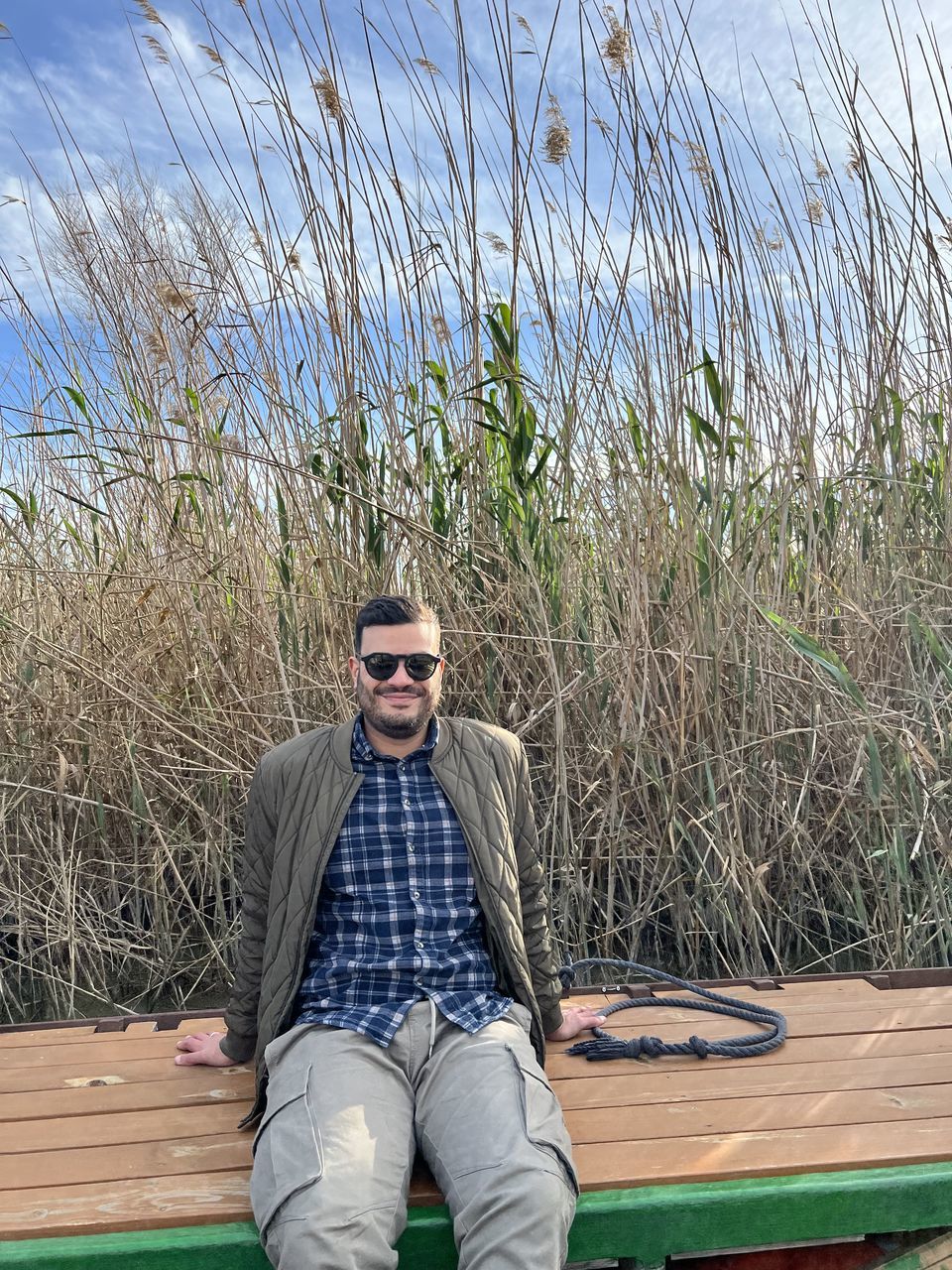 one person, leisure activity, day, lifestyles, nature, water, men, casual clothing, low section, plant, adult, human leg, outdoors, tree, high angle view, spring, shoe, relaxation, grass, lake, clothing, standing, wood, footwear, personal perspective, blue