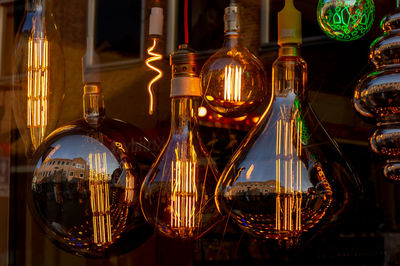 Close-up of illuminated light bulb on table