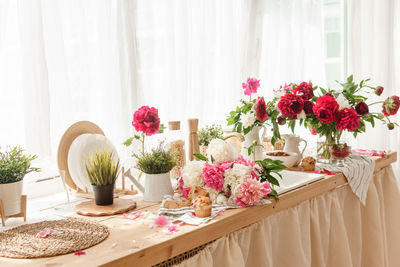 The kitchen countertop is decorated with peonies. the interior is decorated with spring flowers.