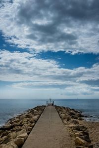 Scenic view of sea against cloudy sky