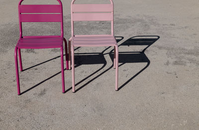 High angle view of empty chairs on beach