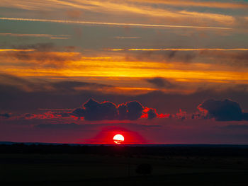 Silhouette landscape against sky during sunset