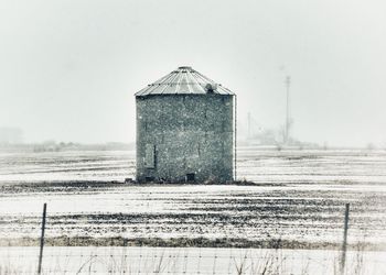 Building on field against clear sky