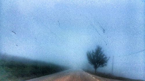 Surface level of road against blue sky