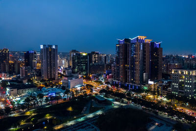 High angle view of illuminated buildings against sky at night