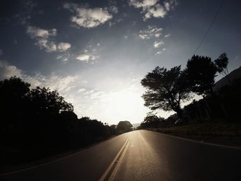 Empty road along trees