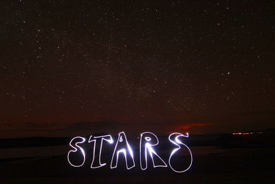 Close-up of light trails against sky at night