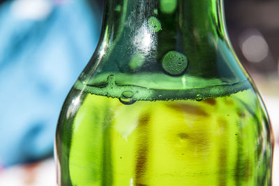 Close-up of green bottle on table