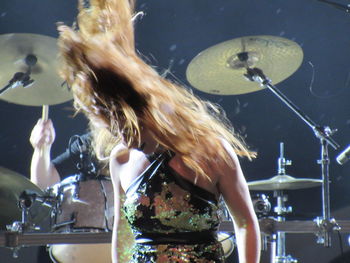 Close-up of senior woman at music concert