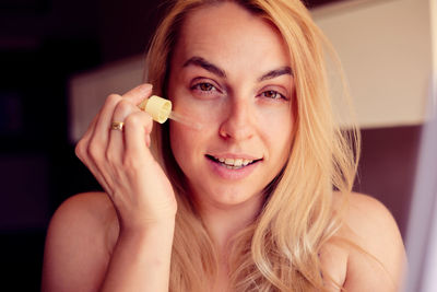 Close-up of young woman with hand