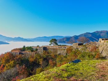 Scenic view of mountains against clear blue sky