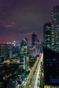 Illuminated cityscape against sky at night