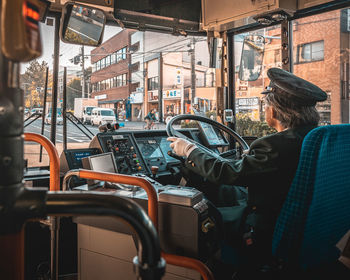 Rear view of woman sitting in bus