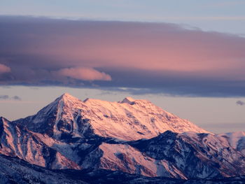 Scenic view of snowcapped mountains against sky during sunset