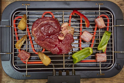 High angle view of meat on barbecue grill