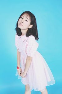 Portrait of girl against pink background