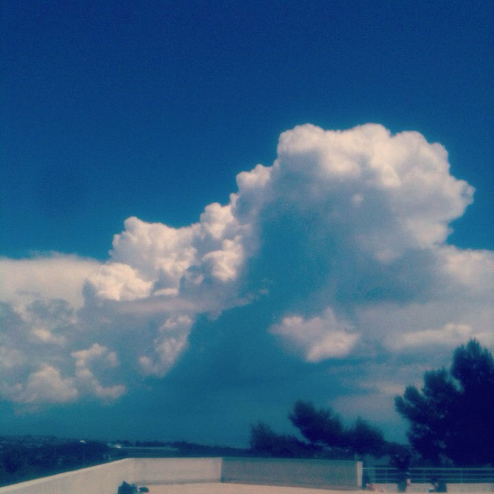 blue, sky, cloud - sky, transportation, cloud, nature, scenics, beauty in nature, tranquility, tranquil scene, copy space, day, outdoors, no people, low angle view, mode of transport, cloudscape, cloudy, idyllic, sunlight