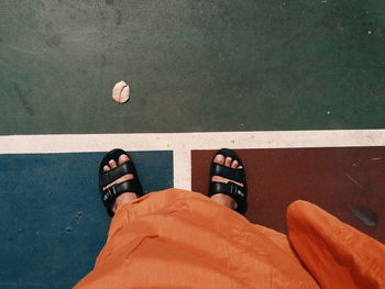 Low section of man standing on floor