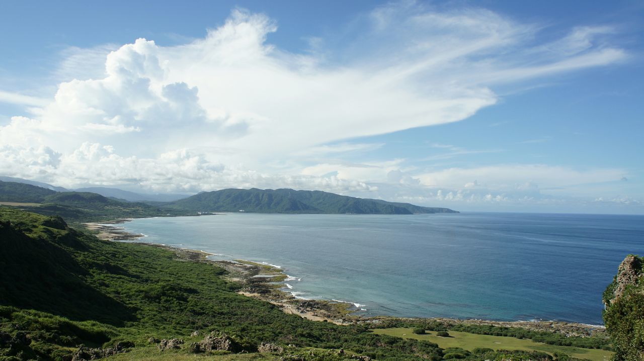 sea, water, tranquil scene, scenics, sky, tranquility, beauty in nature, horizon over water, mountain, nature, cloud - sky, blue, idyllic, coastline, cloud, high angle view, day, shore, beach, outdoors