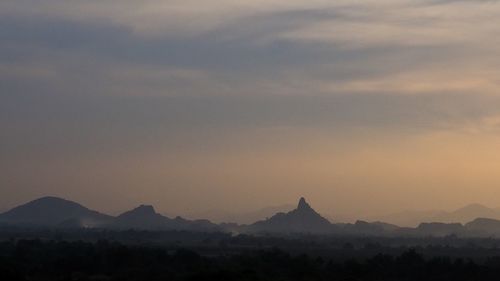 Scenic view of silhouette mountains against sky during sunset