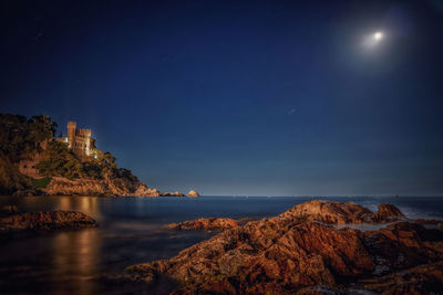 Scenic view of sea against sky at night