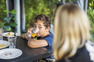 Boy drinking juice at table