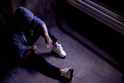 High angle view of woman sitting on street