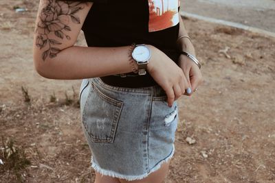 Midsection of woman standing on field