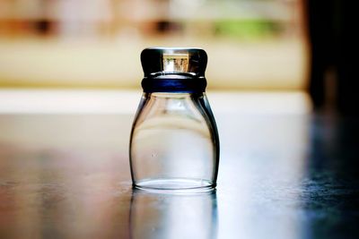 Close-up of glass bottle on table
