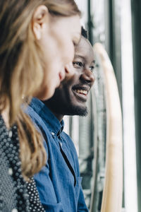 Close-up of businesswoman and man talking at office