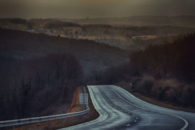 Empty road with mountains in background