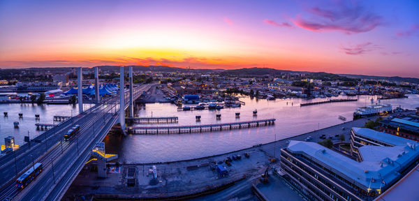 High angle view of boats moored at harbor during sunset