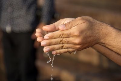 Close-up of hands holding water