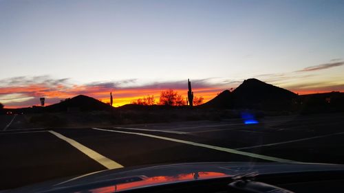 Car on road at sunset