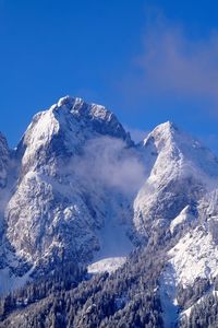 Scenic view of snowcapped mountains against clear blue sky