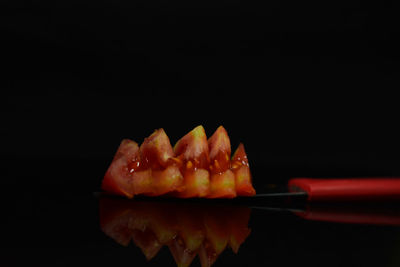 Close-up of burger against black background